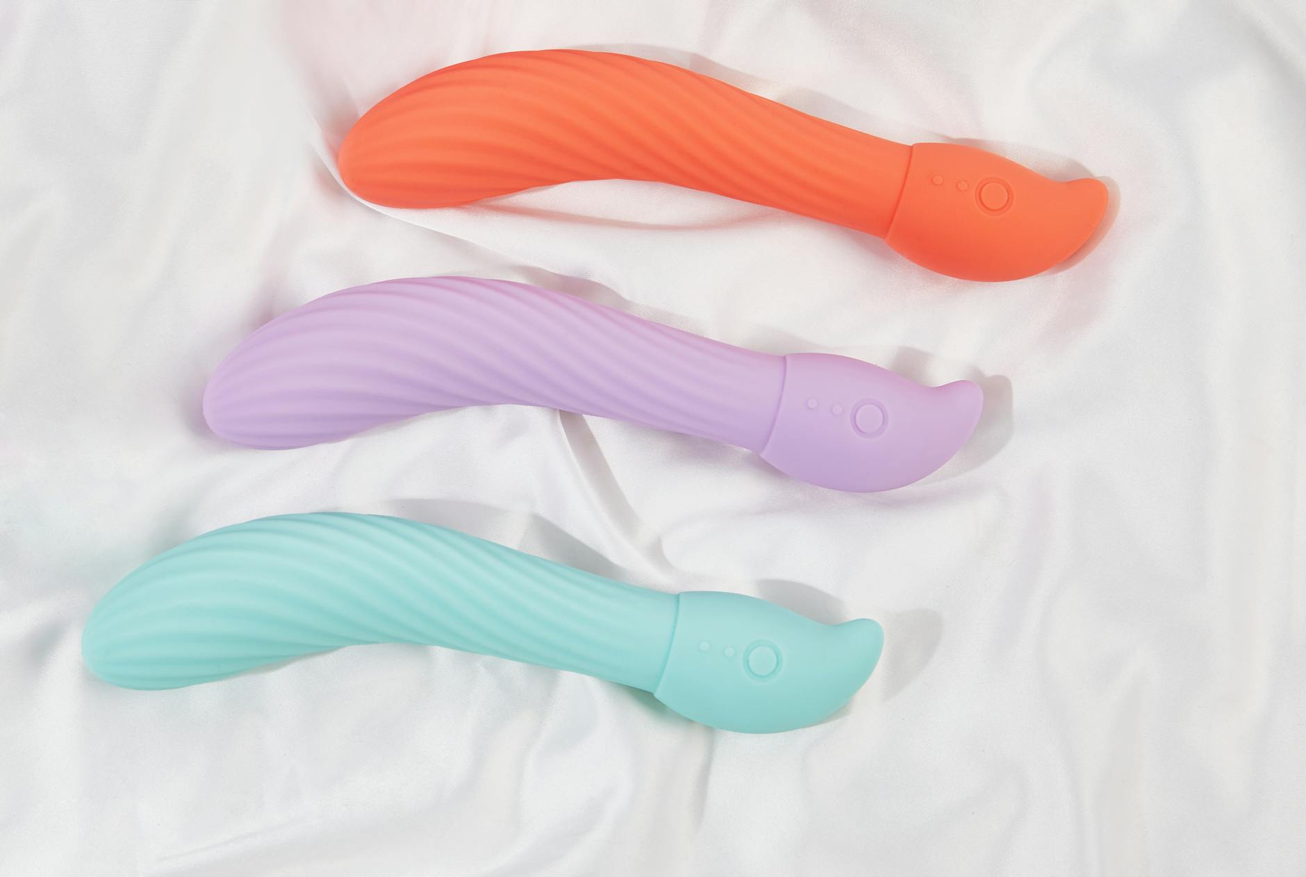 A blue silicone sex toy held in hand against a solid purple background, promoting self-love and sexuality