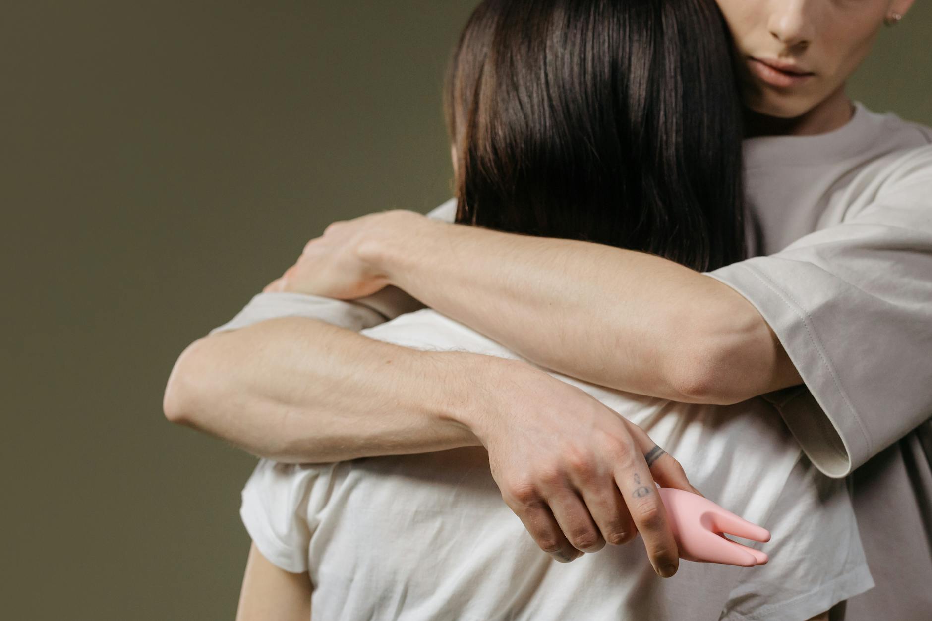 Intimate couple embracing, showing emotional connection and trust in a relationship.