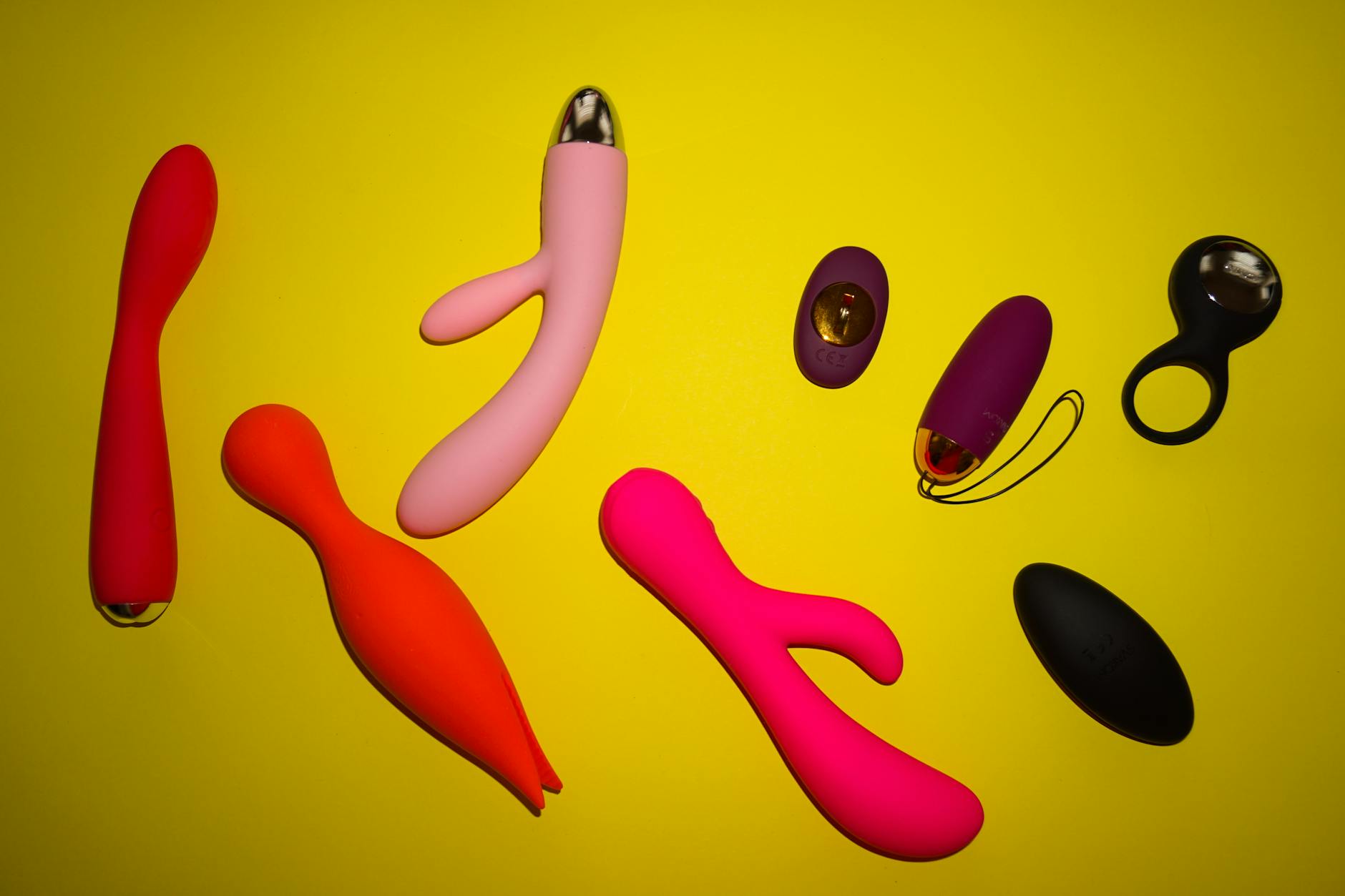 Colorful lemon and other vibrators displayed on a bright yellow background